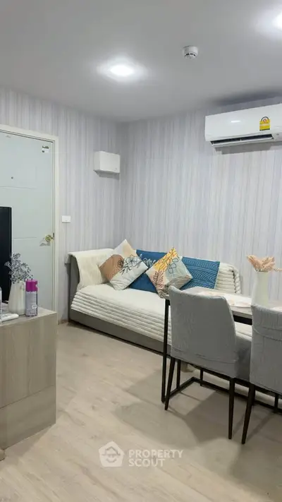 Modern living room with stylish decor and air conditioning in a cozy apartment.