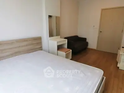 Cozy bedroom with wooden flooring and modern furniture in a minimalist style.