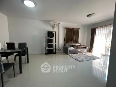 Spacious living room with modern decor and ample natural light