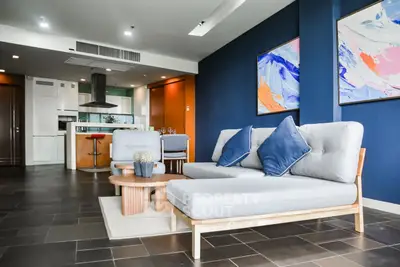 Modern living room with stylish decor and open kitchen layout in a contemporary apartment.