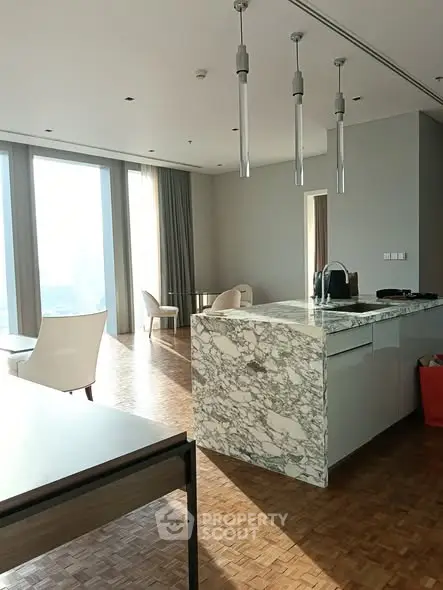 Luxurious modern living room with marble island and panoramic windows.