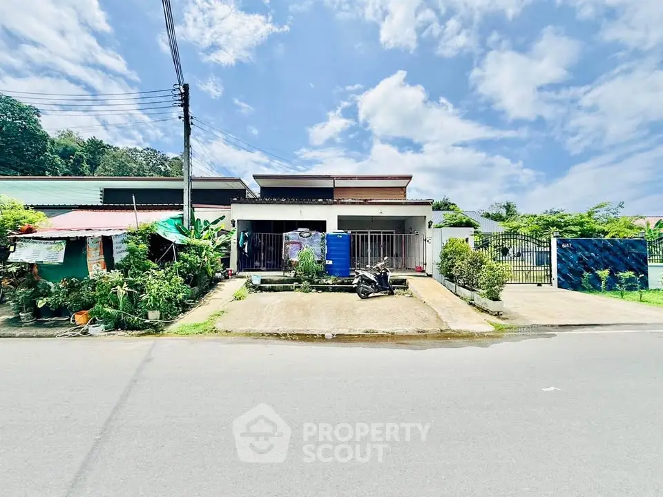 Charming single-story home with lush garden and driveway in a serene neighborhood.