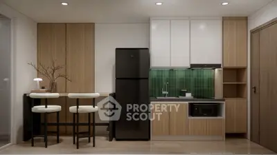 Modern kitchen with sleek black appliances and stylish green backsplash