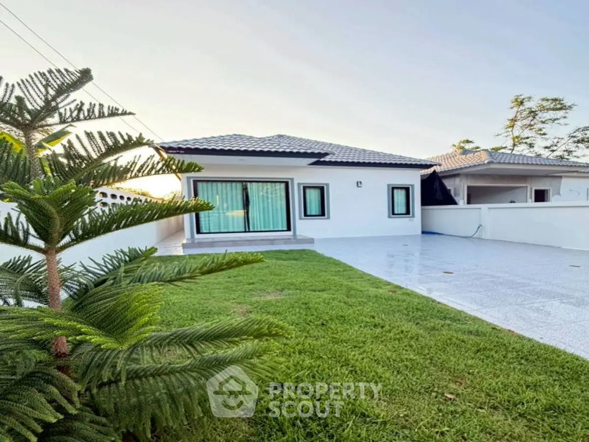 Charming single-story home with spacious yard and modern exterior design.