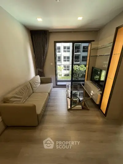 Modern living room with sleek furniture and large window view
