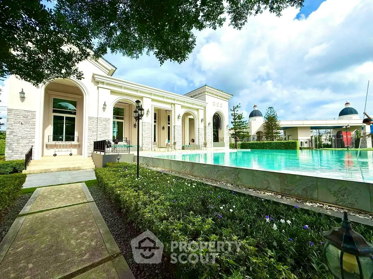 Luxurious villa with stunning pool and elegant architecture surrounded by lush greenery.