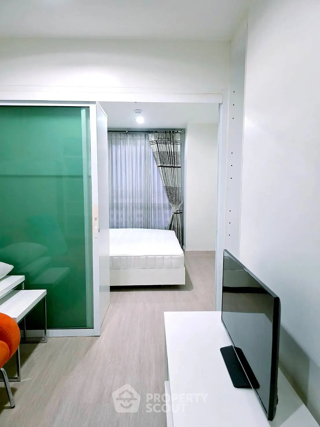Modern studio apartment with sleek design and cozy bedroom area