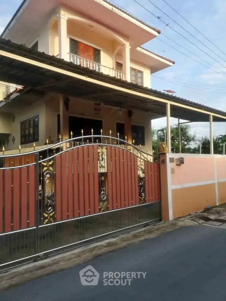 Charming two-story house with gated entrance and covered carport in a serene neighborhood.