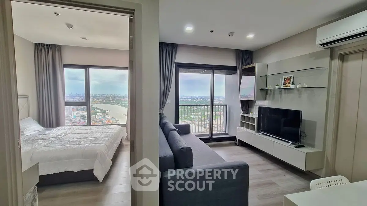 Modern apartment with spacious living room and bedroom, featuring large windows and a stunning city view.