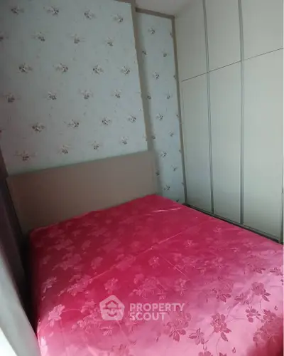 Cozy bedroom with floral wallpaper and built-in wardrobe