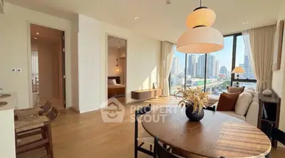 Spacious modern living room with city view, open layout, and elegant decor.