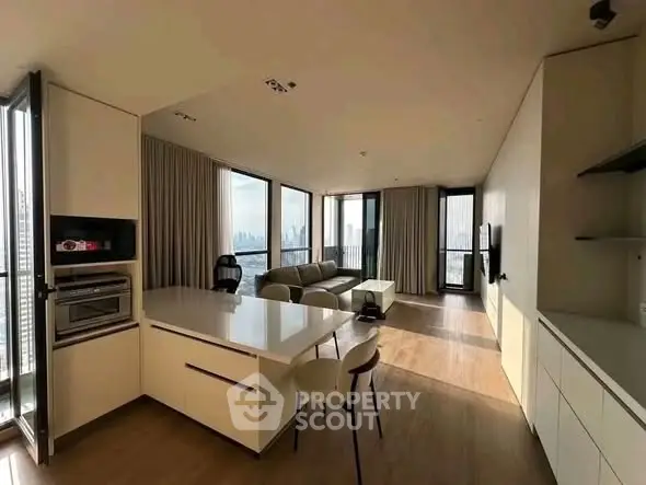 Spacious modern living room with open kitchen and stunning city view