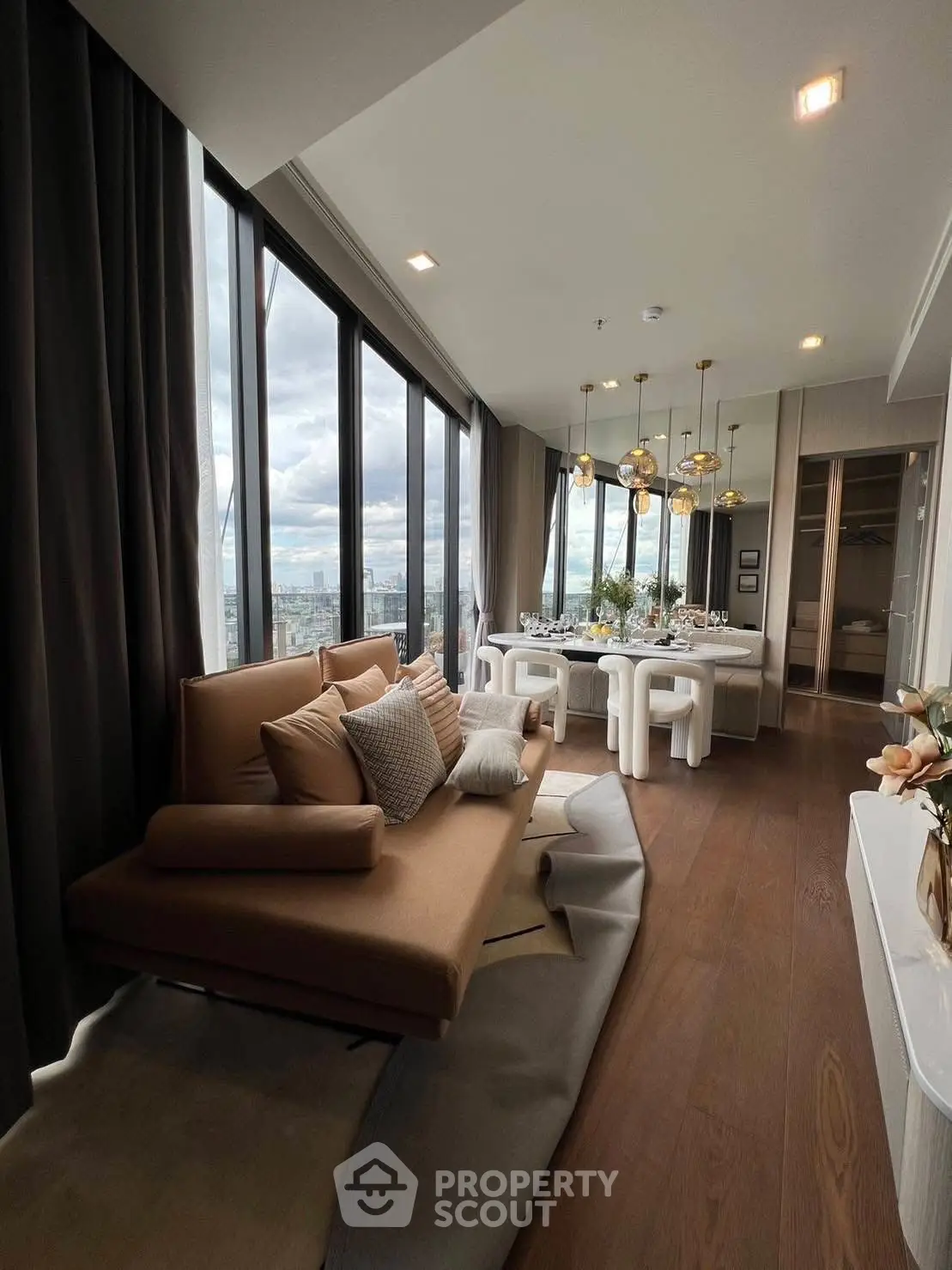 Luxurious modern living room with panoramic city views and elegant dining area