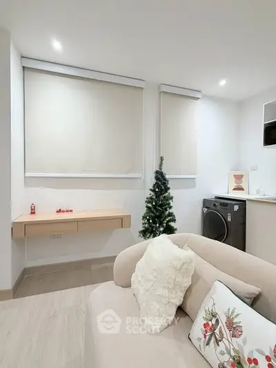 Cozy living room with modern decor and compact laundry area