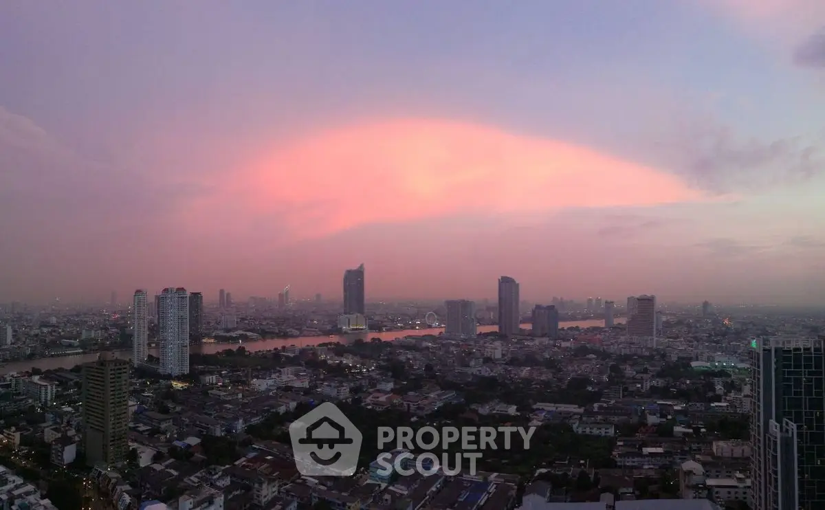 Stunning cityscape view at sunset with vibrant sky over urban skyline.