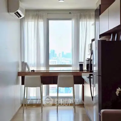 Modern kitchen with city view, sleek appliances, and stylish seating for two.