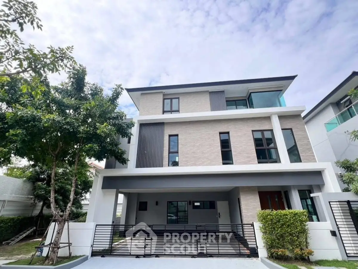 Modern three-story house with sleek design and spacious driveway in a serene neighborhood.