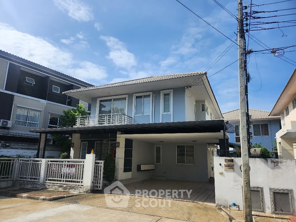Modern two-story house with spacious driveway and contemporary design in suburban neighborhood.