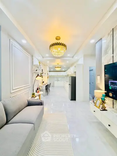 Luxurious open-plan living room with elegant chandelier and modern decor