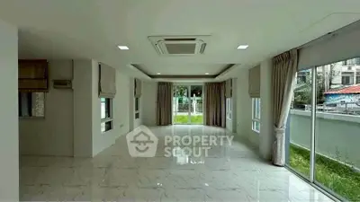 Spacious empty room with large windows and marble flooring, perfect for customization.