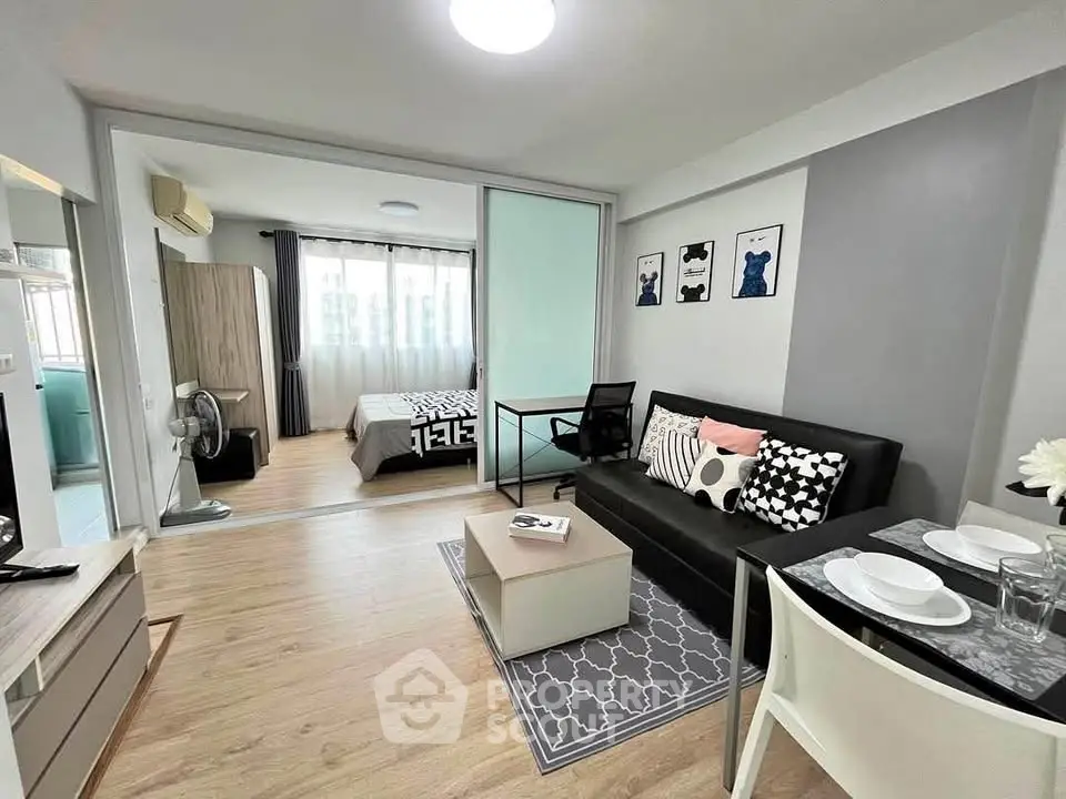 Modern open-plan living room and bedroom with stylish decor and natural light.