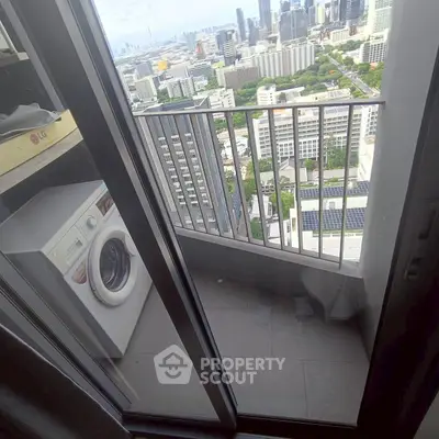 High-rise apartment balcony with city view and washing machine