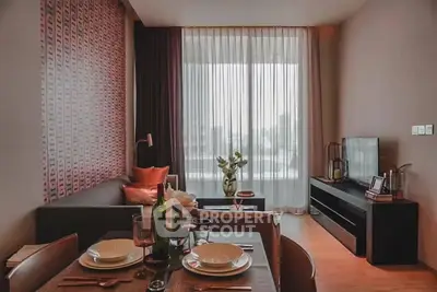 Modern living room with stylish decor and large window offering natural light.