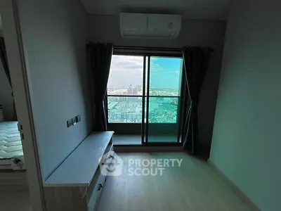 Modern bedroom with balcony view in high-rise apartment