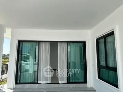 Modern balcony with sliding glass doors and scenic view, perfect for relaxation and outdoor enjoyment.