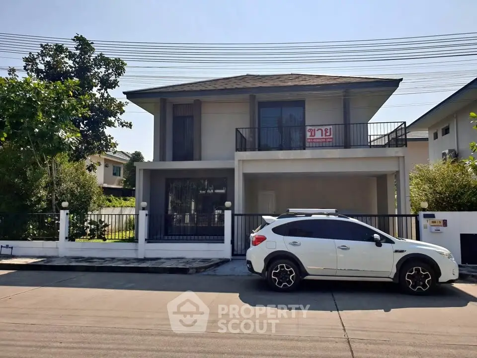 Charming two-story house with balcony and driveway, featuring a modern white SUV parked in front.