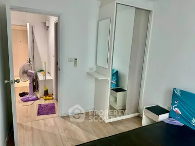 Modern bedroom with mirrored wardrobe and wooden flooring in a stylish apartment.