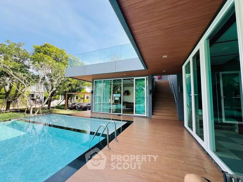Luxurious modern home with stunning pool and spacious outdoor deck, perfect for relaxation and entertainment.