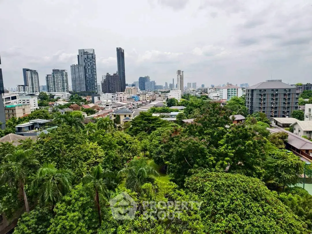 Stunning cityscape view with lush greenery and modern skyscrapers.