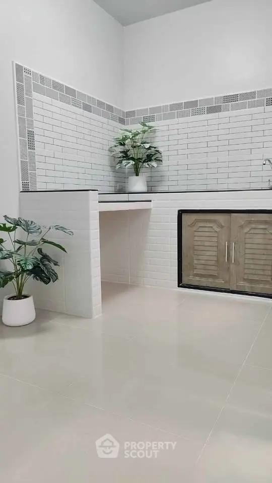 Modern minimalist kitchen with white subway tiles and sleek cabinetry.