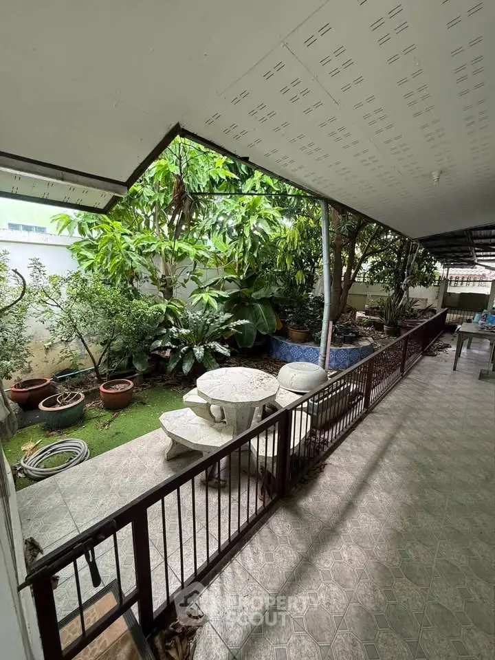 Charming garden view with patio seating in a serene residential setting.