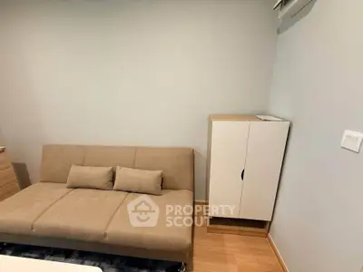 Cozy living room with beige sofa and modern cabinet