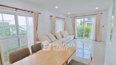 Bright and airy living room with large windows and modern furniture