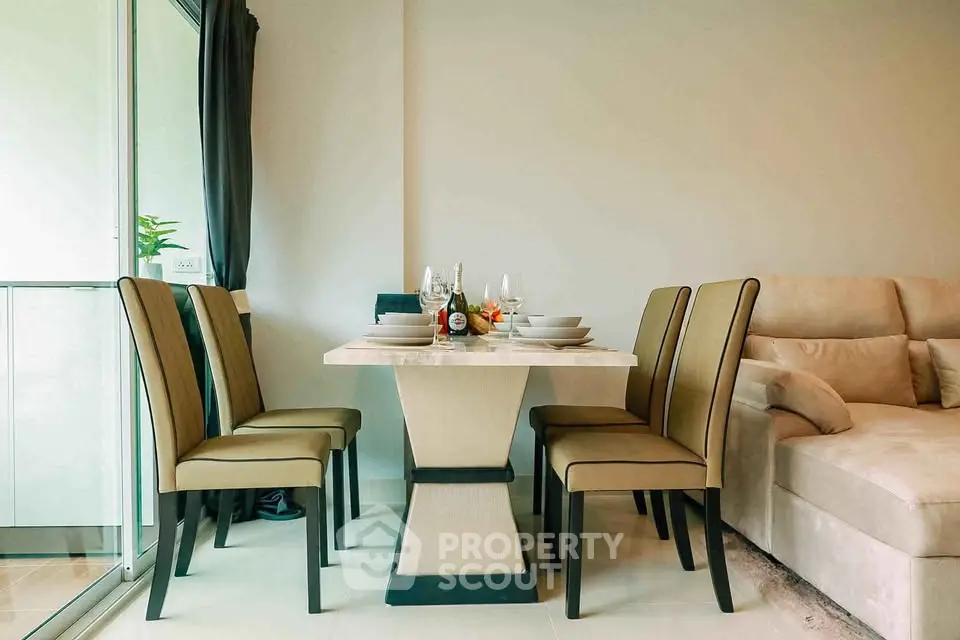 Elegant dining area with modern table and chairs in a cozy living room setting.