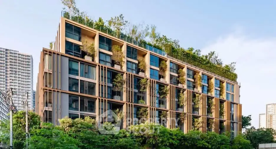 Modern eco-friendly building with lush greenery and rooftop garden