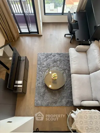 Modern living room with stylish furniture and balcony view, perfect for urban living.