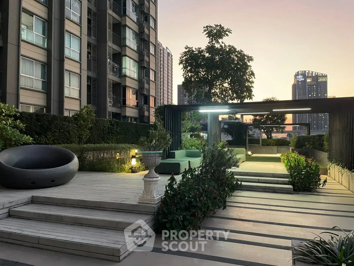 Modern rooftop garden with stylish seating and city view at sunset