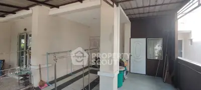 Spacious covered outdoor area with tiled flooring and storage space