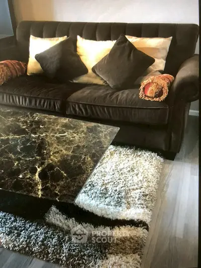 Stylish living room with plush sofa and elegant marble coffee table on a cozy rug.