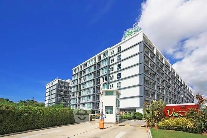 Modern apartment building with lush greenery and clear blue sky