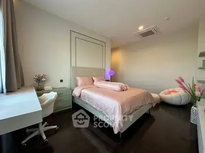 Elegant bedroom with modern decor and natural light, featuring a cozy bed and stylish furnishings.