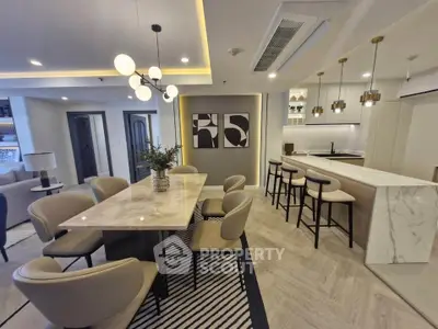 Luxurious open-plan living and dining area with modern decor and elegant lighting, perfect for entertaining.