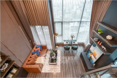 Luxurious high-ceiling living room with modern decor and panoramic city view.