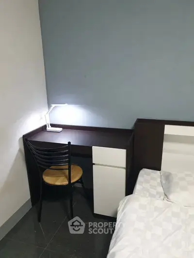 Cozy bedroom corner with desk and modern lamp