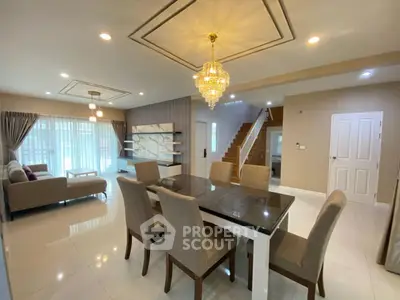 Elegant dining area with chandelier and modern decor in spacious living room