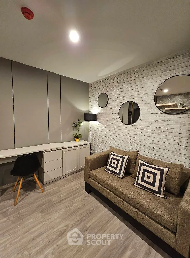Modern living room with stylish decor and cozy seating area, perfect for relaxation and work-from-home setup.